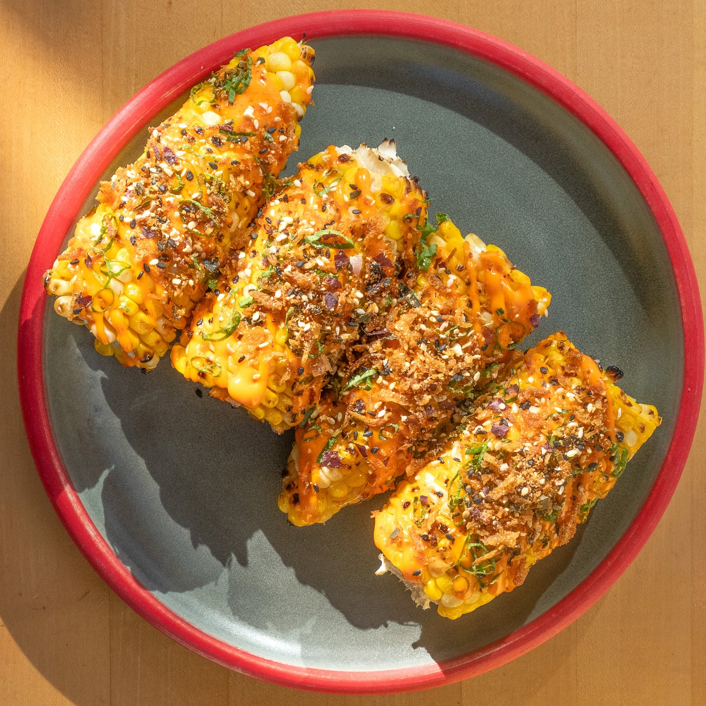 The Honey Paw's Grilled Corn with Chili Aioli, Scallion, and Umai Ocean Blend