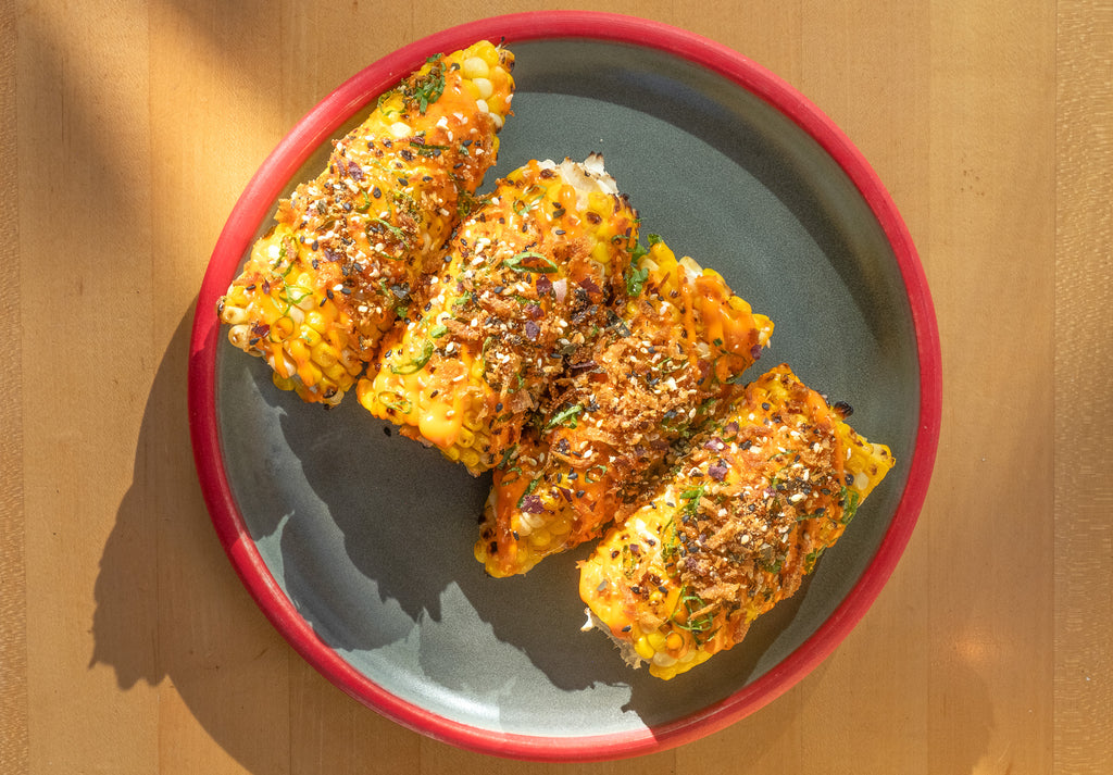 The Honey Paw's Grilled Corn with Chili Aioli, Scallion, and Umai Ocean Blend